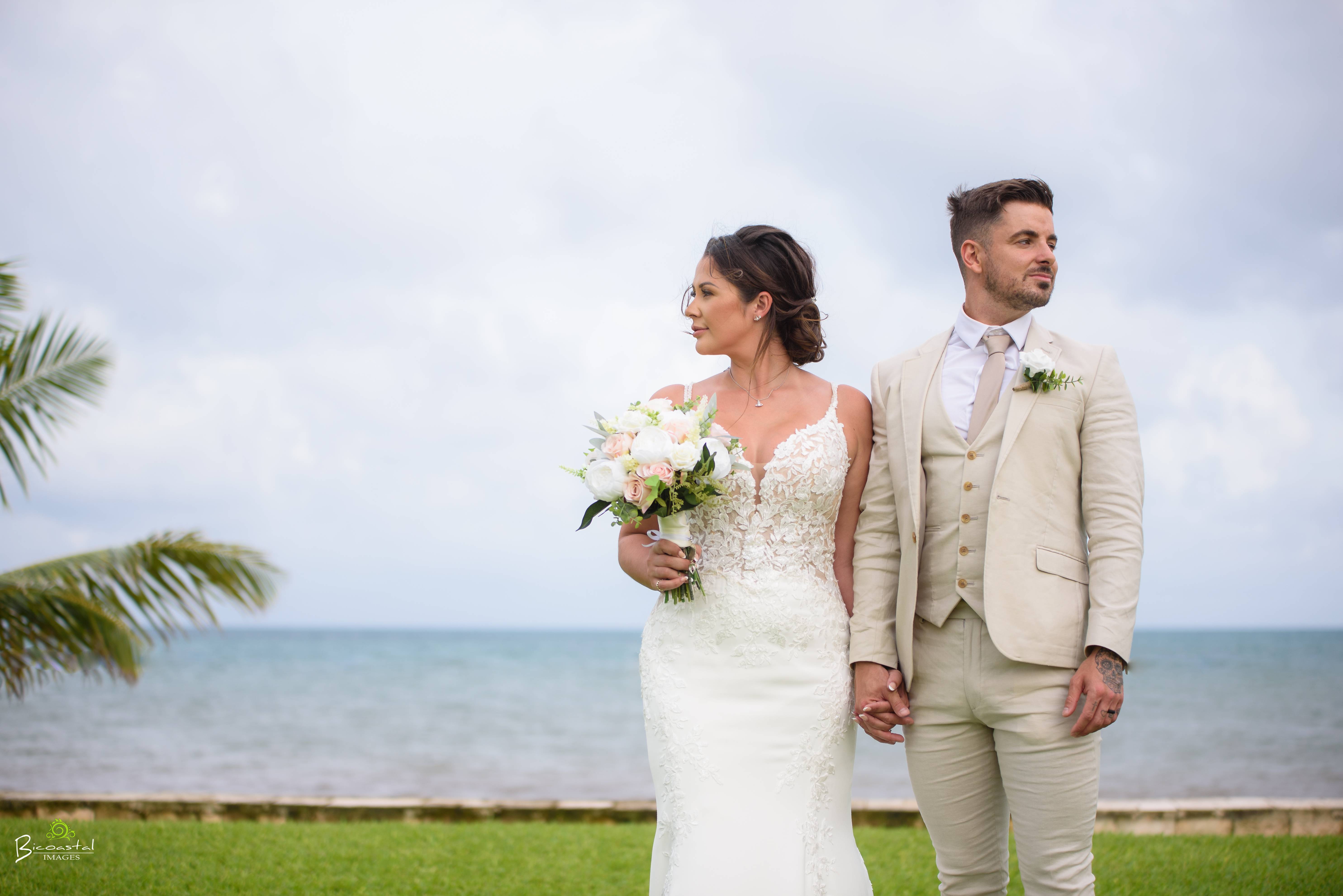 Formal couple portrait with bouquet and beige suits