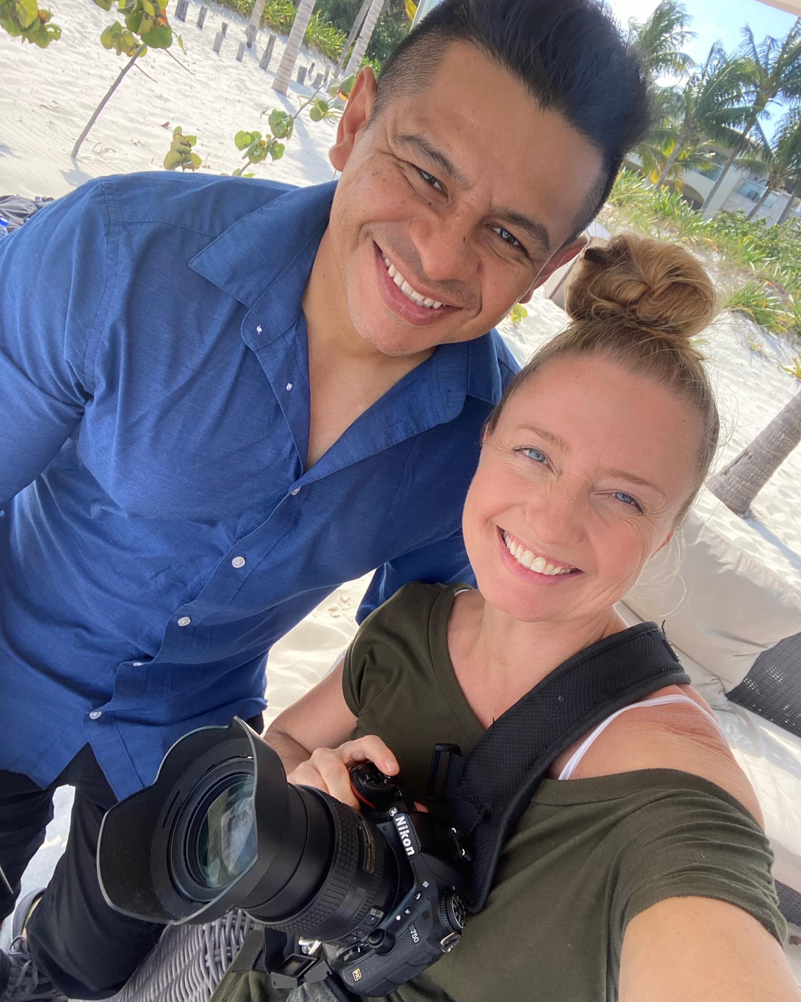 Manuel and Jennifer, destination wedding photographers, with professional camera equipment at a tropical resort location