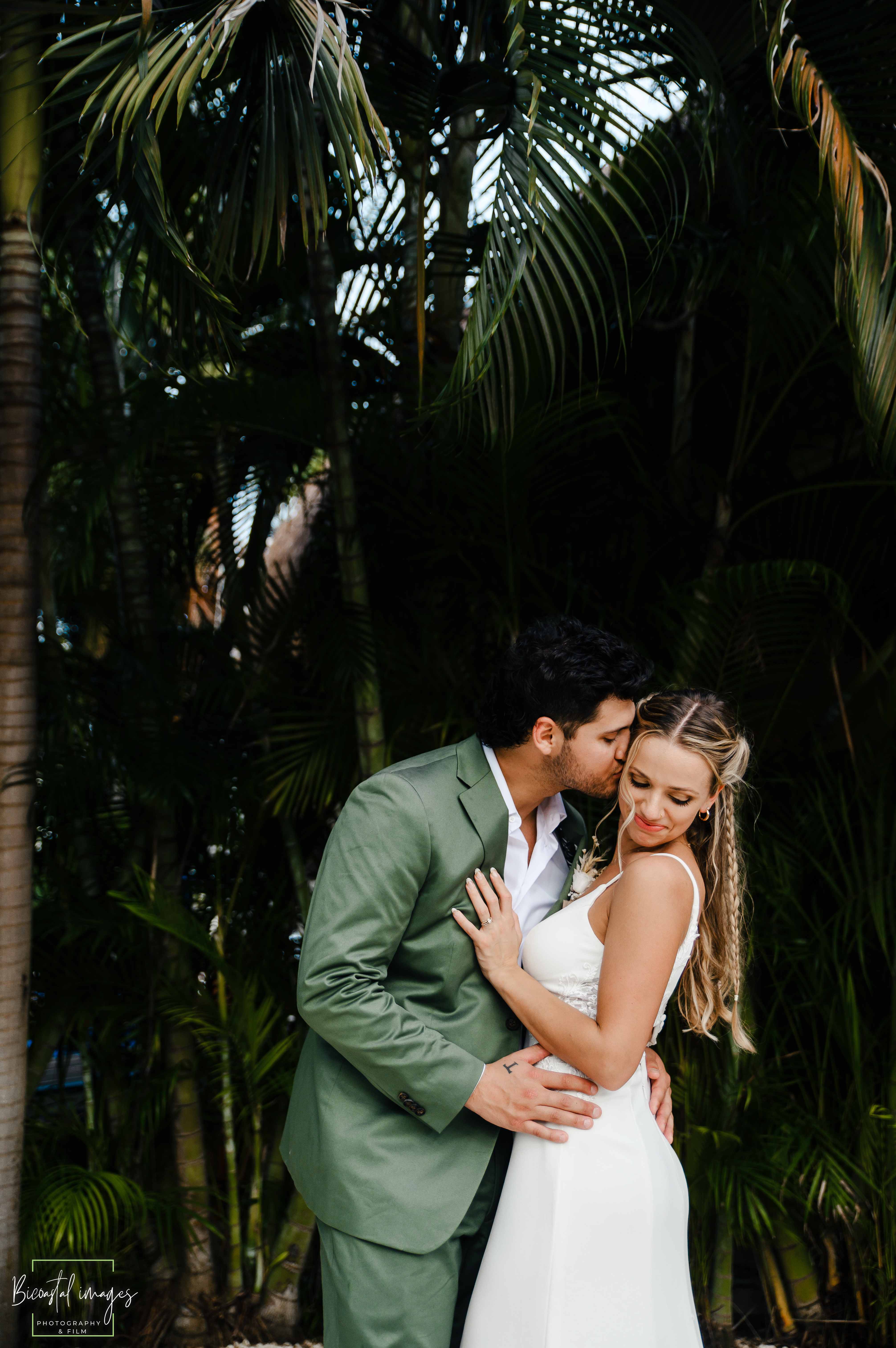 Romantic couple embrace in lush tropical palm setting